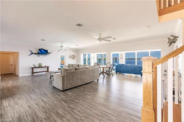 Living room with ornamental molding, ceiling fan, and hardwood / wood-style floors
