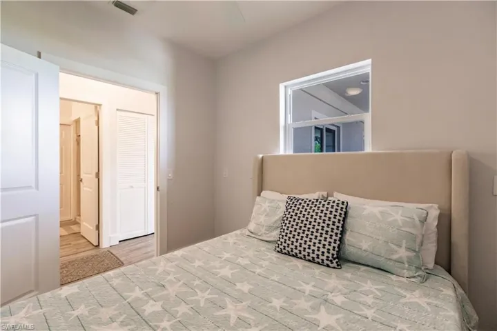 Bedroom with hardwood / wood-style flooring and ensuite bath
