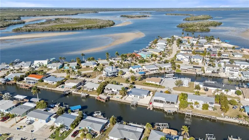 Aerial view of property's location with nearby suburban area and a nearby body of water