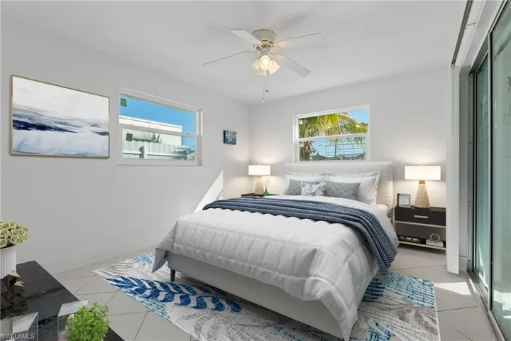(Virtually Staged)       Bedroom featuring a ceiling fan and light tile patterned floors
