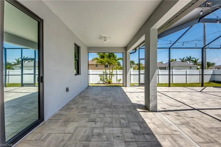 View of patio / terrace with a lanai and fence