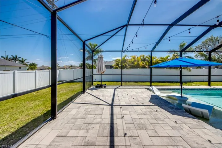 View of patio / terrace with glass enclosure, a fenced backyard, and a fenced in pool