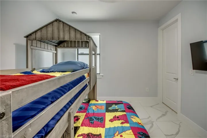 Bedroom with baseboards and marble finish floor