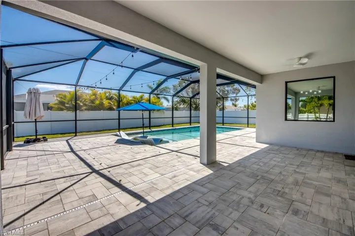 View of pool featuring a lanai, a fenced backyard, a fenced in pool, and a patio area