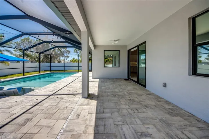 View of pool with a lanai, a fenced in pool, fence private yard, and a patio area