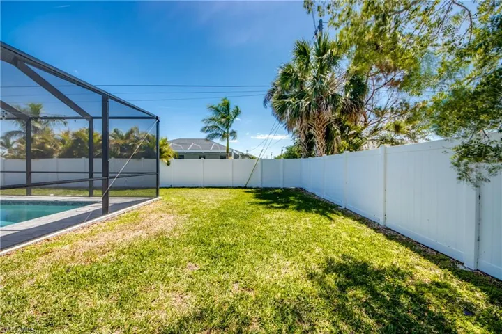 View of yard featuring a lanai, a fenced backyard, and a fenced in pool