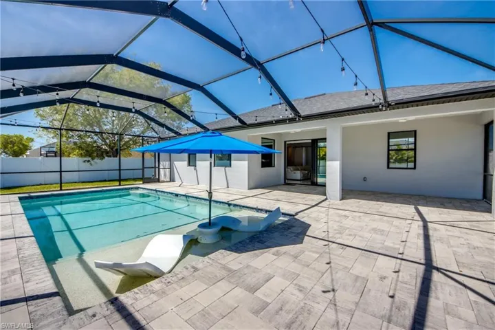 View of pool with a patio, fence, a lanai, and a fenced in pool