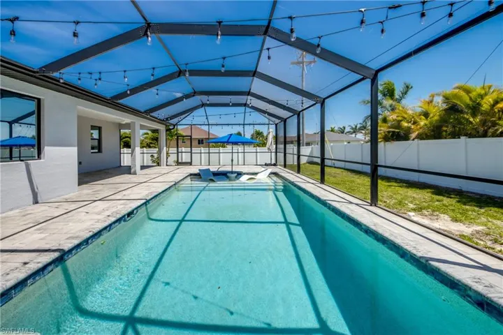 View of swimming pool featuring a patio, a lanai, a fenced backyard, and a fenced in pool
