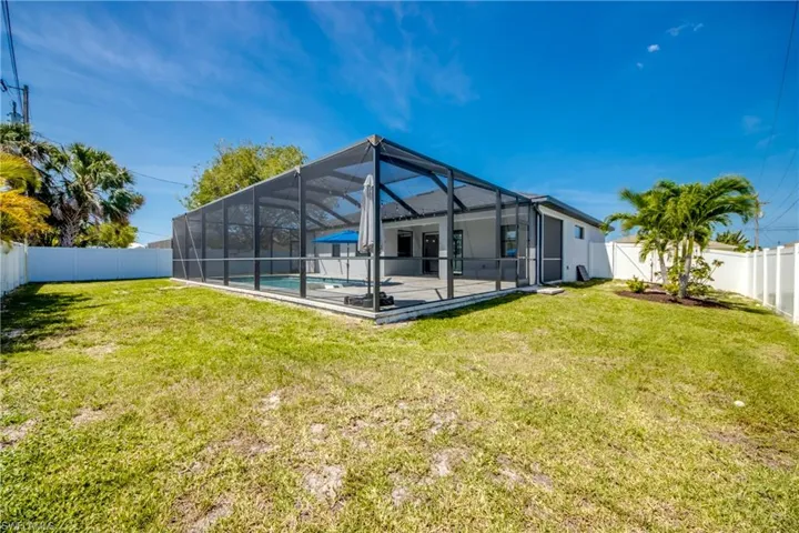Rear view of house featuring a fenced in pool, a yard, a patio area, and a fenced backyard