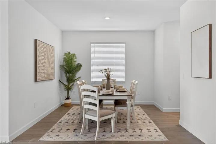 The property features a dining area with wood-look flooring, a window with blinds, and recessed lighting