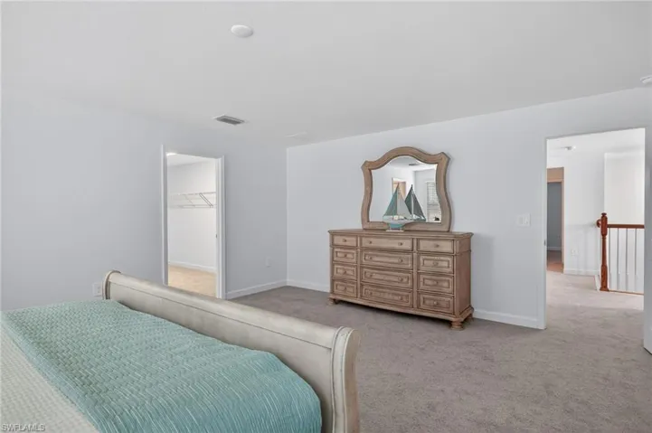 This room features light-colored walls and grey carpet flooring