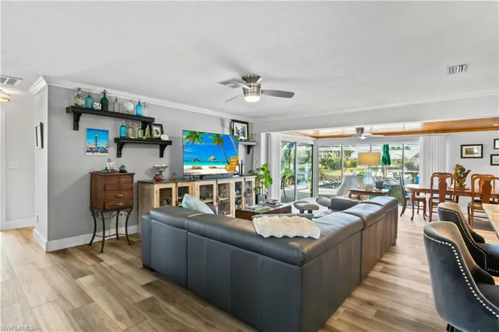 Living room showcasing refined finishes and connection to dining and kitchen.