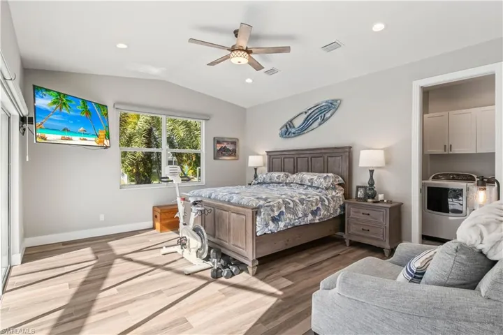 Spacious primary bedroom with abundant natural light and serene backyard views.