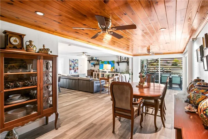 Dining area featuring a warm wood-accent ceiling for a sophisticated touch.