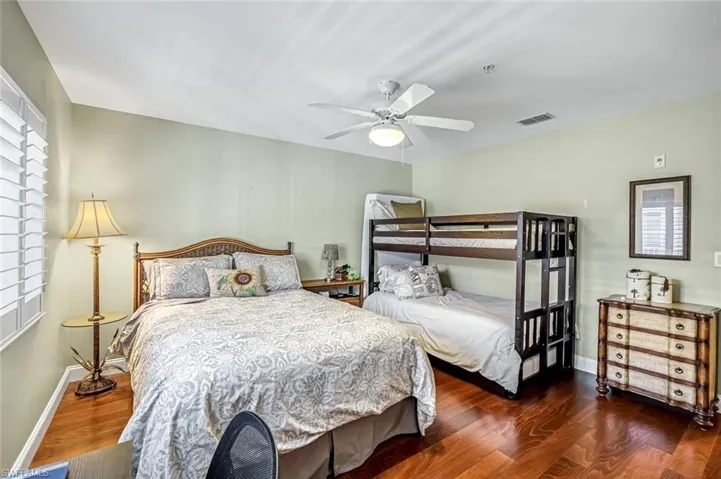 Bedroom featuring dark wood-style flooring and ceiling fan