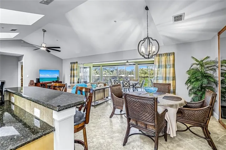 Dining room with a ceiling fan and a skylight