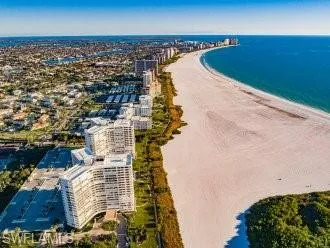 Aerial view with a water view and a beach view