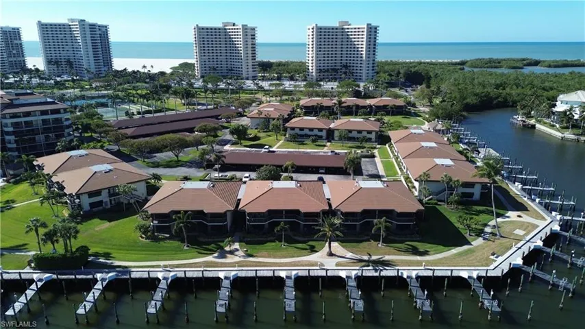Birds eye view of property with a water view