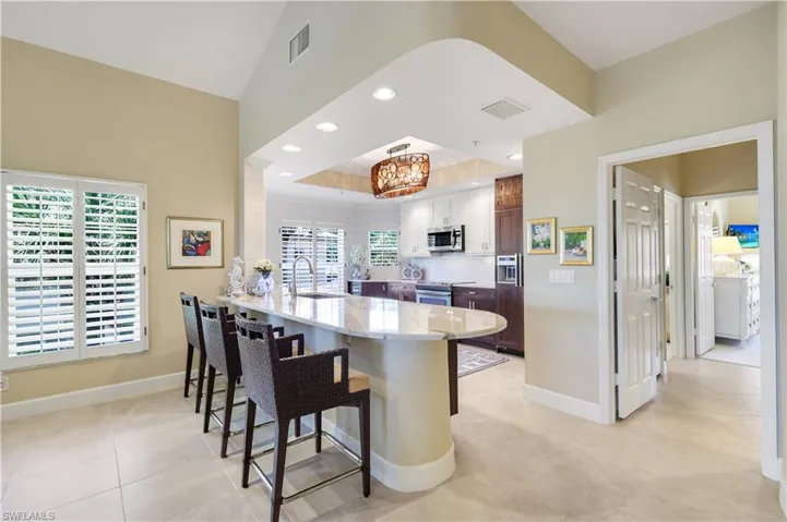 The breakfast bar keeps the kitchen open and connected to the living areas.