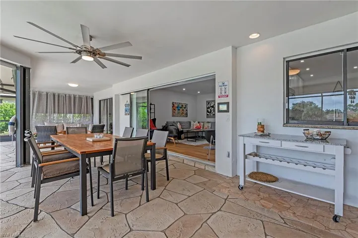 Outdoor dining area with access inside to living area