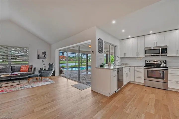 Kitchen with flow into living area and access to lanai