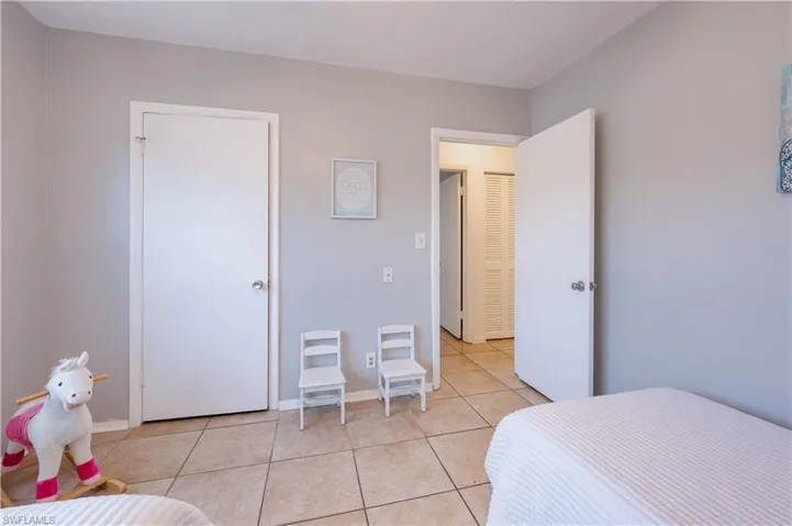 Bedroom #2 featuring light tile patterned floors and baseboards