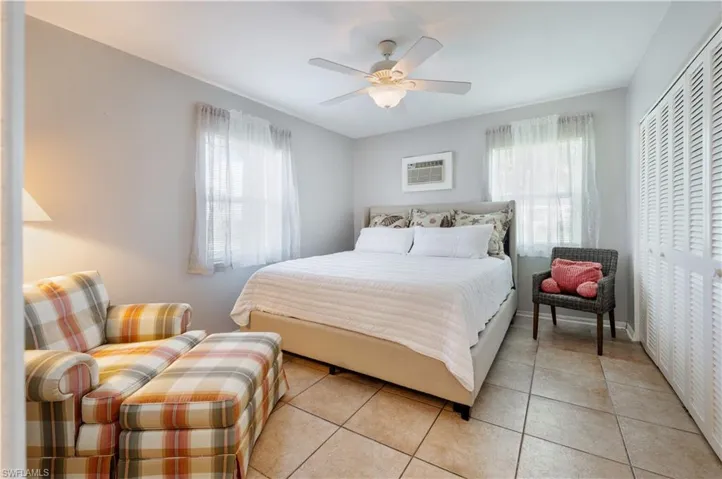 Bedroom with tile patterned floors, a ceiling fan, and a closet
