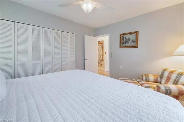 Bedroom featuring ceiling fan and a closet