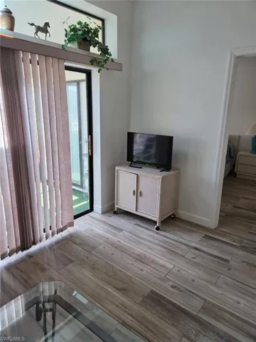 Unfurnished living room with light wood-style flooring and baseboards