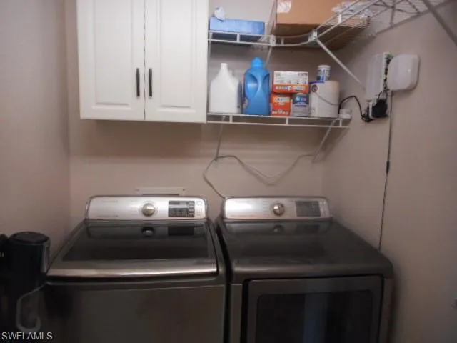 Washroom with cabinet space and separate washer and dryer