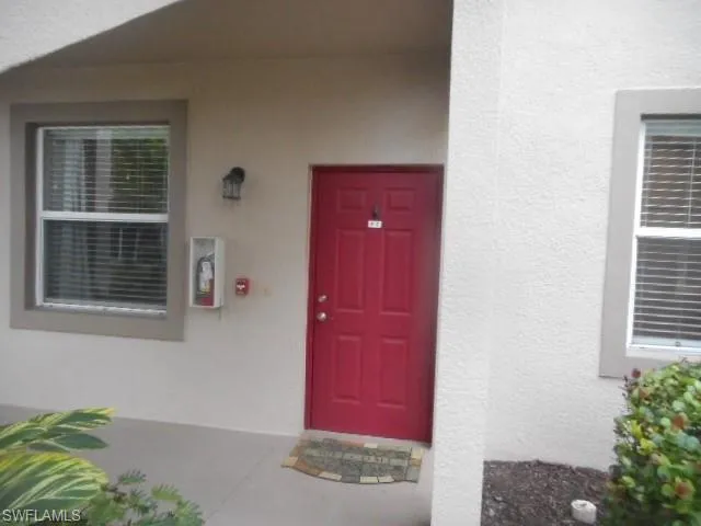 Entrance to property with stucco siding