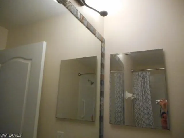 Bathroom featuring a shower with shower curtain