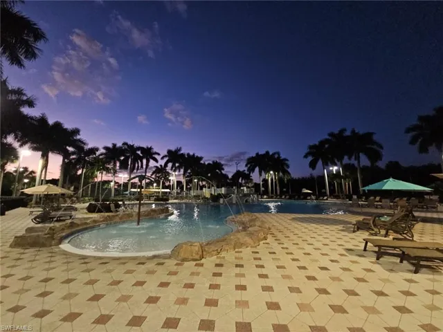 Community pool with a patio
