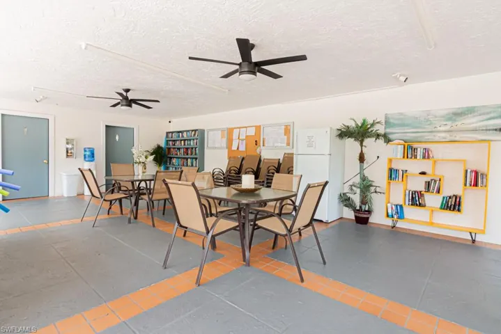 Dining area featuring tile patterned floors, a textured ceiling, and a ceiling fan