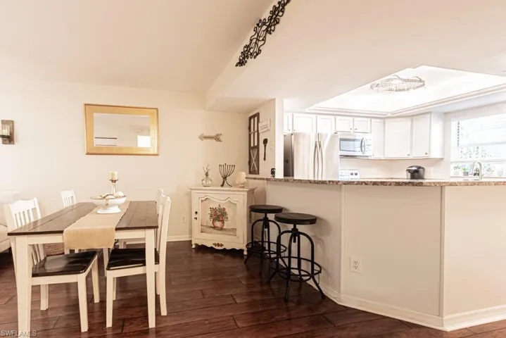 Dining room featuring baseboards and dark wood-type flooring