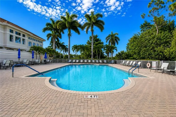 Outdoor swimming pool with integrated steps, surrounded by a paver patio