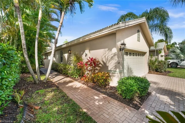 View of home's exterior with stucco siding, an attached garage, and driveway