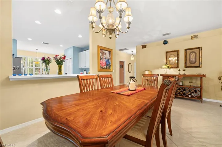 Dining room featuring suspended lighting and light tile patterned floors