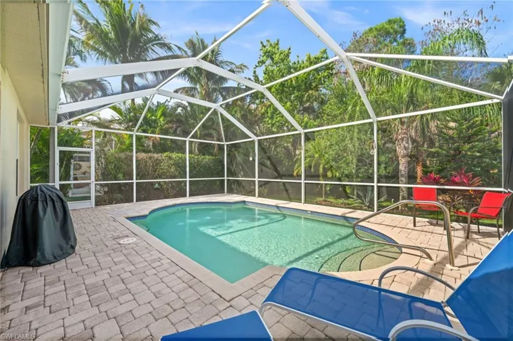 Outdoor pool featuring a patio, a lanai, a sunroom, and grilling area