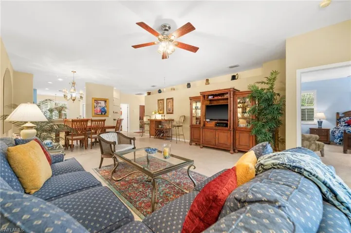 Living room with ceiling fan and hanging lights