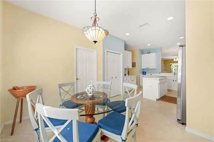 Dining space with recessed lighting and light tile patterned floors