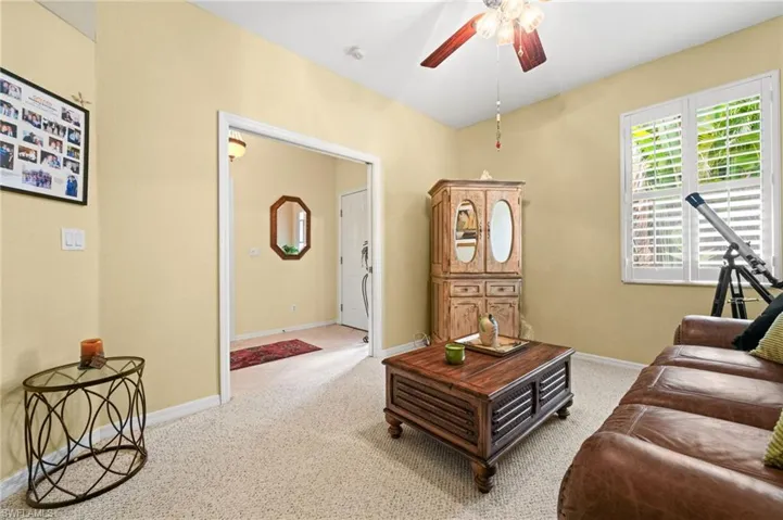 Living room featuring a ceiling fan and carpet