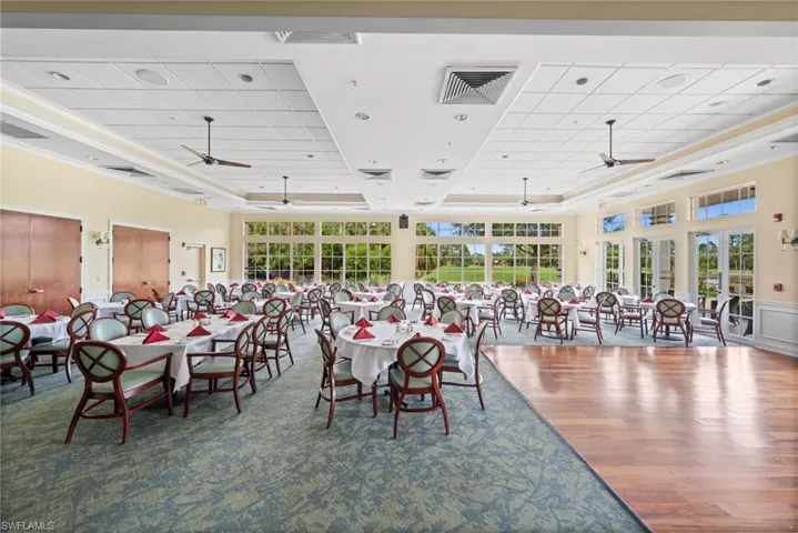 Dining area with ceiling fan, ornamental molding, a tray ceiling, and dark wood finished floors