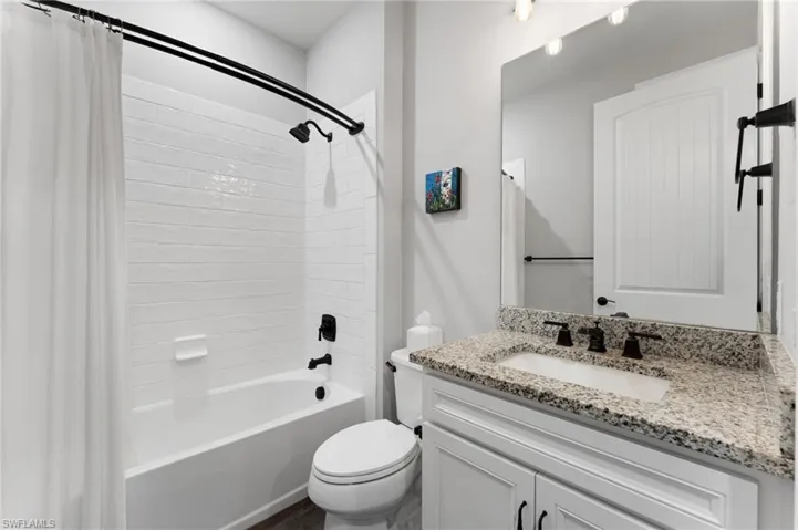 Full bathroom featuring vanity, toilet, and shower / bath combo