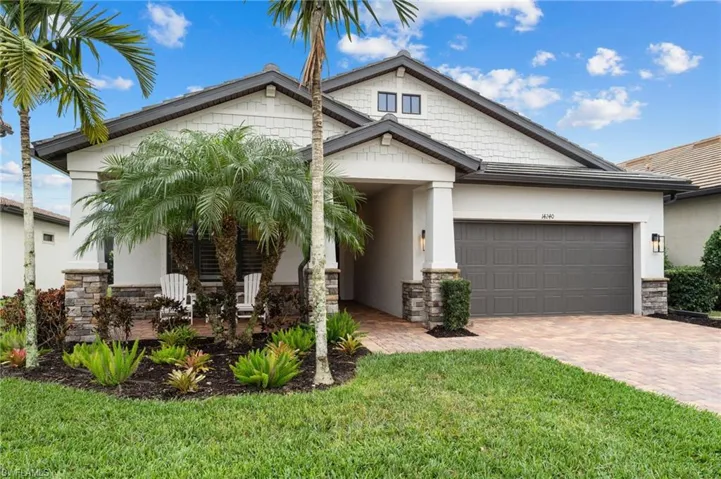 View of front of house featuring a garage and a front lawn