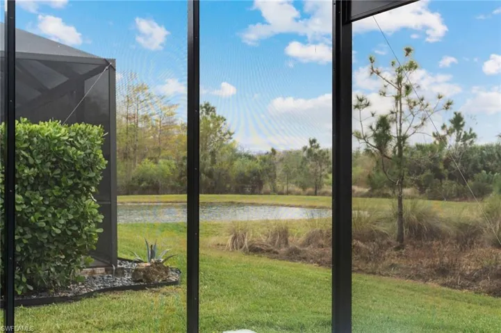 View of yard featuring a water view and a lanai
