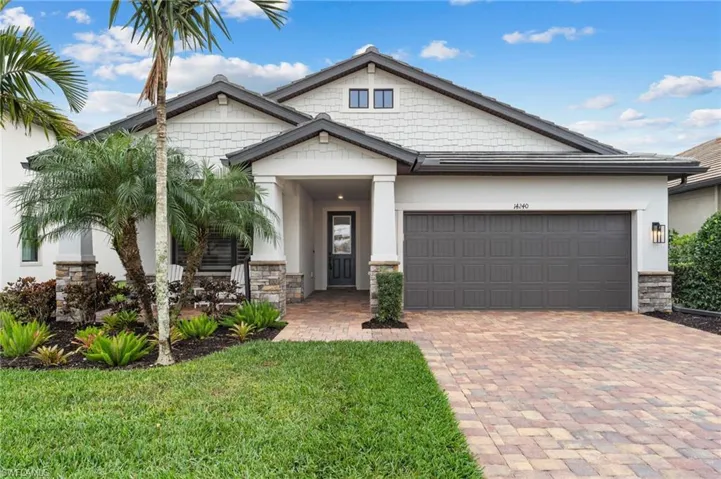 Craftsman inspired home with a garage and a front yard