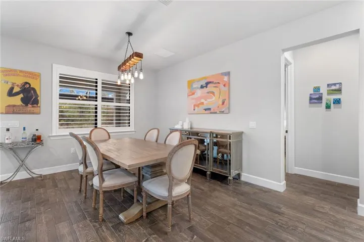 Dining area with dark hardwood / wood-style flooring