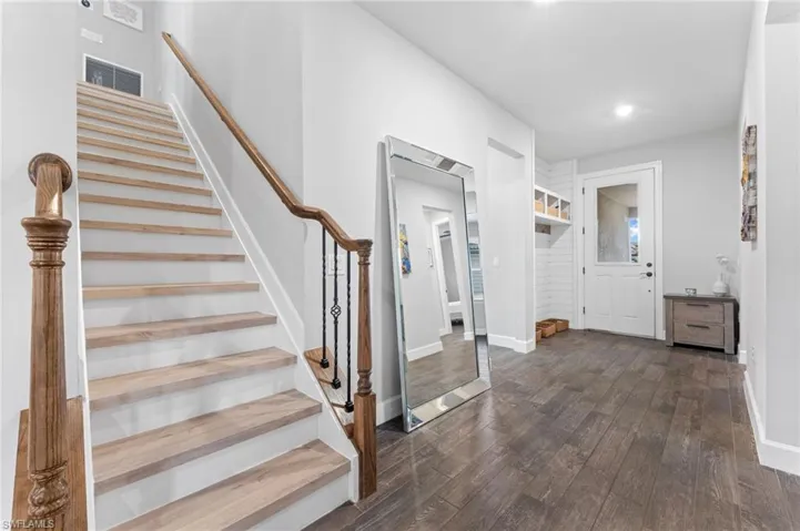 Entrance foyer with dark hardwood / wood-style flooring