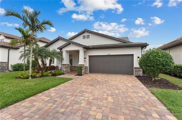 View of front of house with a garage and a front yard